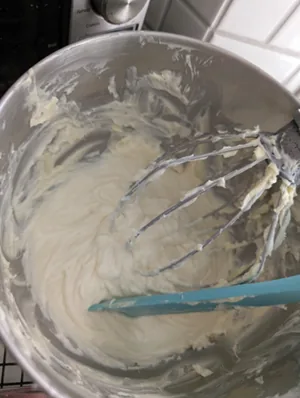 Ermine frosting mixed in a metal stand mixer bowl